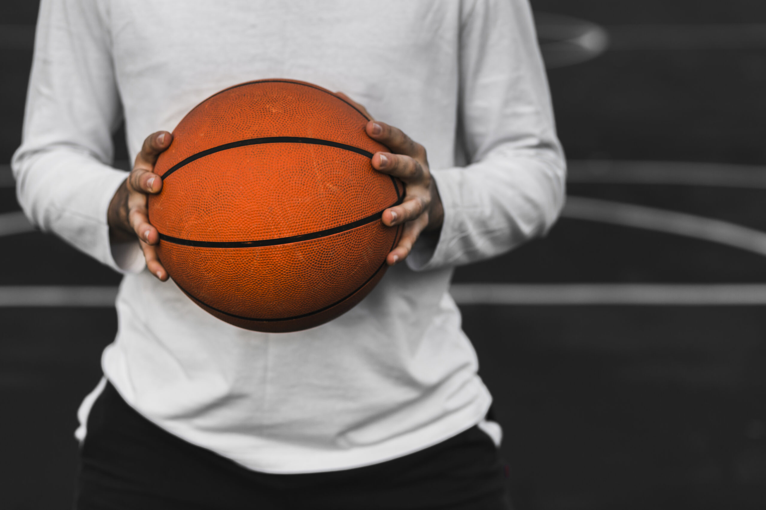 unrecognisable-player-holding-basketball
